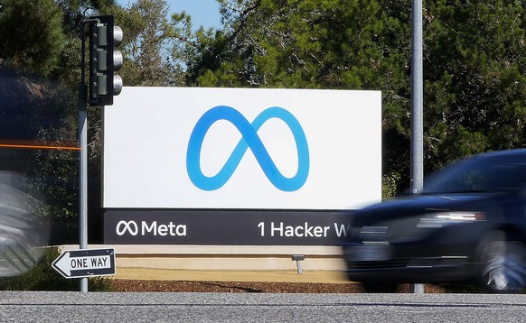 FILE - A car passes Facebook&#039;s new Meta logo on a sign at the company headquarters, on Oct. 28, 2021, in Menlo Park, Calif. A Nigerian advertising regulator has sued Meta, accusing the owner of F ...