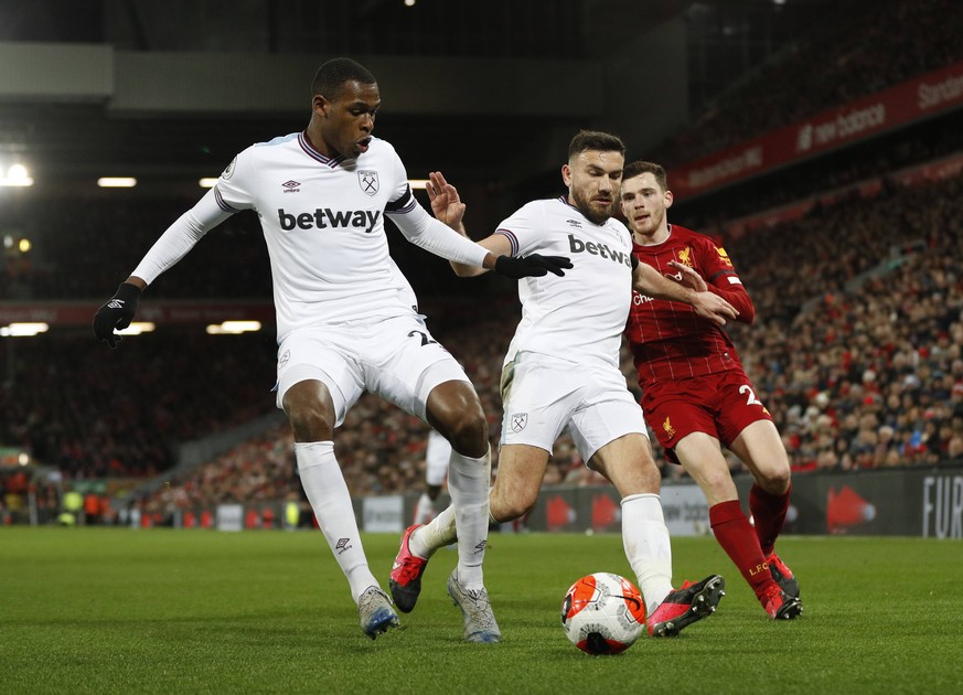 Issa Diop of West Ham United and Robert Snodgrass of West Ham United keep out Andrew Robertson of Liverpool during the Premier League match at Anfield, Liverpool. Picture date: 24th February 2020. Pic ...