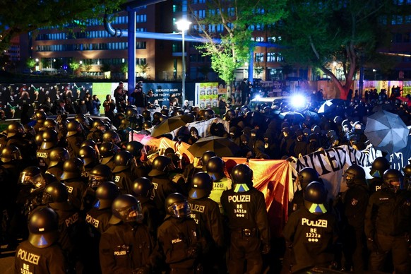 Police officers gather in front of demonstrators during the protest &quot;Take Back The Night - queer feminists fight back&quot; during so-called Walpurgis Night ahead of May Day in Berlin, Germany, A ...