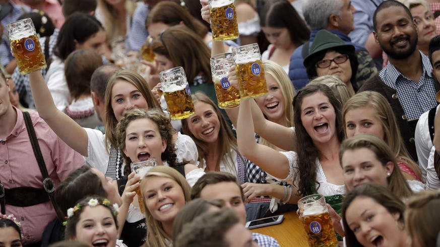 Young people celebrate the opening of the 185th &#039;Oktoberfest&#039; beer festival in Munich, Germany, Saturday, Sept. 22, 2018. The world&#039;s largest beer festival will be held from Sept. 22 un ...