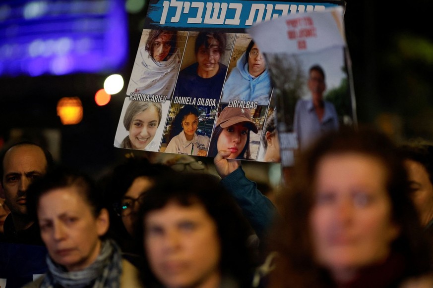 Families of hostages and supporters block a road as they take part in a protest calling for their release amid the ongoing conflict between Israel and the Palestinian Islamist group Hamas, in Tel Aviv ...