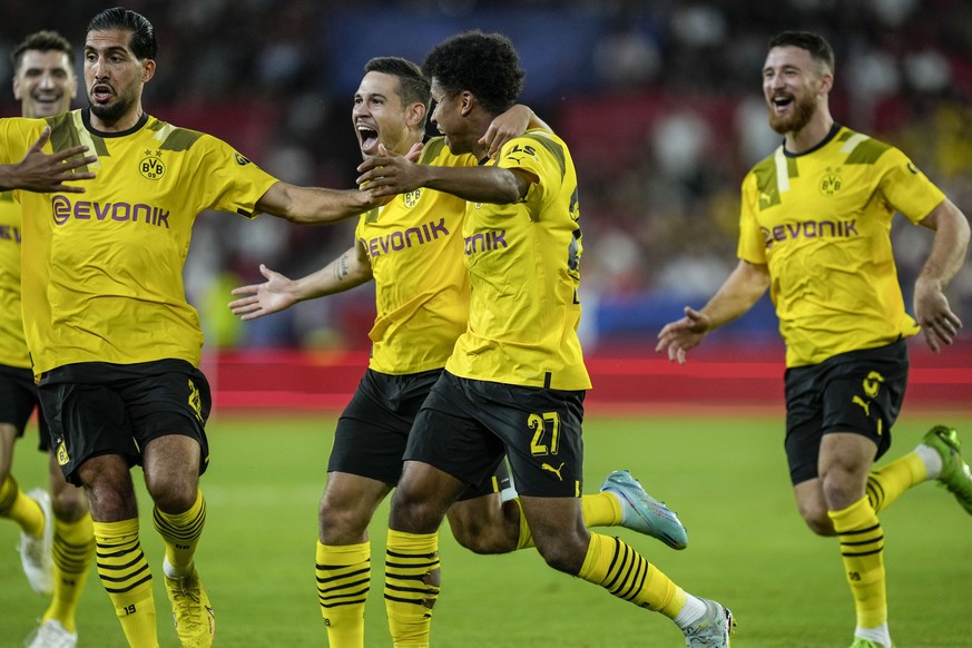 Dortmund&#039;s Raphael Guerreiro, center, celebrates after scoring the opening goal during the group G Champions League soccer match between Sevilla and Borussia Dortmund at the Ramon Sanchez Pizjuan ...