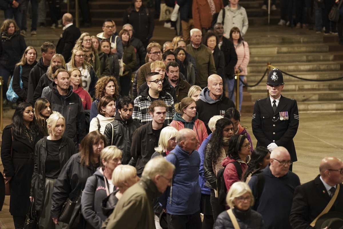 People file past the coffin of Queen Elizabeth II as it lies in state on the catafalque in Westminster Hall, at the Palace of Westminster, London, early Saturday Sept. 17, 2022. The Queen will lie in  ...