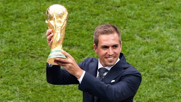 MOSCOW, RUSSIA - JULY 15, 2018: 2014 FIFA World Cup WM Weltmeisterschaft Fussball champion, retired German footballer Philipp Lahm holds the trophy ahead of the 2018 FIFA World Cup Final match between ...