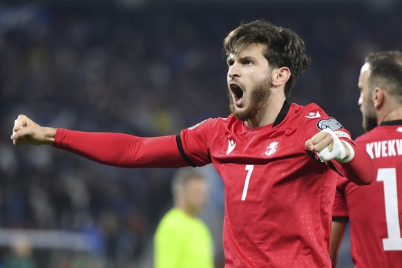 Georgia&#039;s Khvicha Kvaratskhelia, right, celebrates after scoring his side&#039;s second goal during the Euro 2024 group A qualifying soccer match between Georgia and Scotland at the Boris Paichad ...