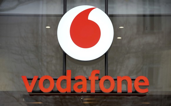 FILE - The logo of the mobile service provider &#039;vodafone&#039; is pictured on the entrance of a company&#039;s store at the Kurfuerstendamm shopping boulevard in Berlin, Germany, Tuesday, Feb. 1, ...