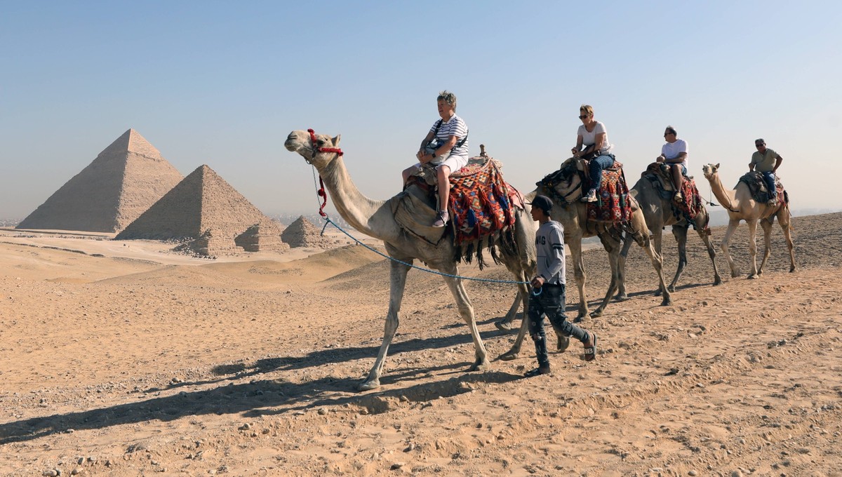 Tourism in Egypt Tourists ride camels as they visit the Giza Plateau, home of the Great Pyramids of Giza, in Giza, Egypt, 24 October 2024. According to the Deputy Minister of Tourism and Antiquities f ...