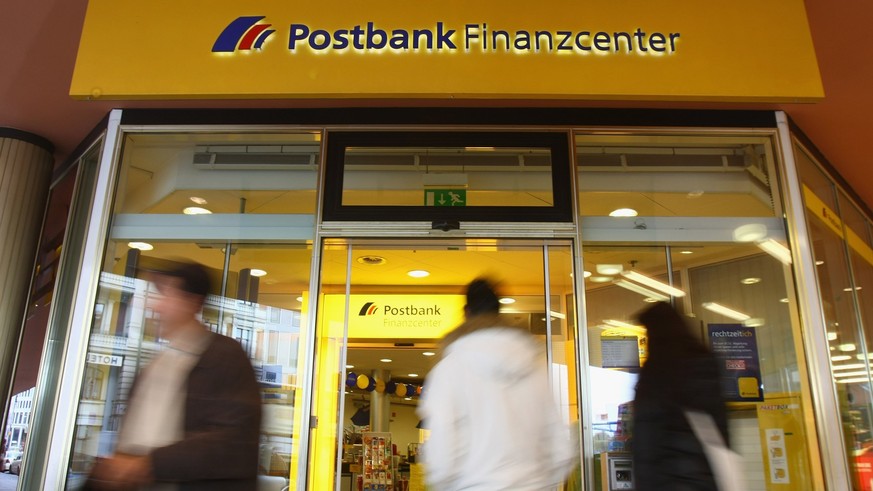 BERLIN - OCTOBER 28: People walk past a branch of German bank Postbank on October 28, 2008 in Berlin, Germany. Postbank announced third quarter losses of EUR 449 million, mainly due to investments rel ...