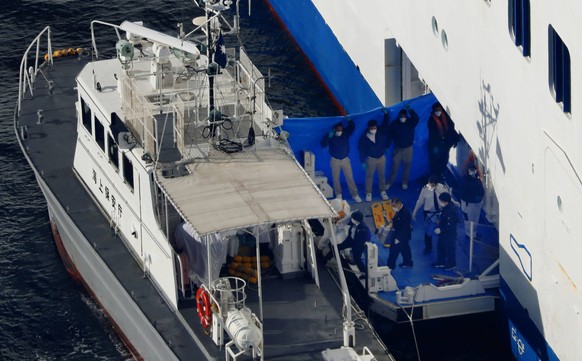 New coronavirus Photo taken from a Kyodo News helicopter on Feb. 5, 2020, shows a Japan Coast Guard patrol boat pulling up beside luxury cruise ship Diamond Princess which has been kept at anchor off  ...