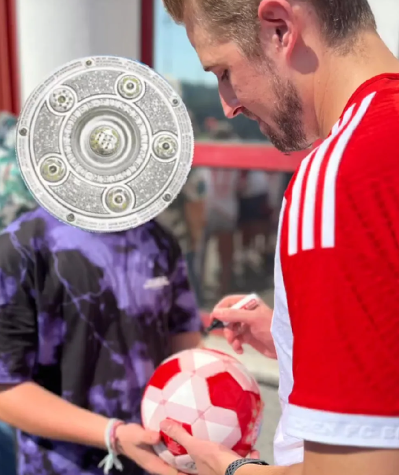 "Harry Kane" gibt einem Bayern-Fan ein Autogramm.