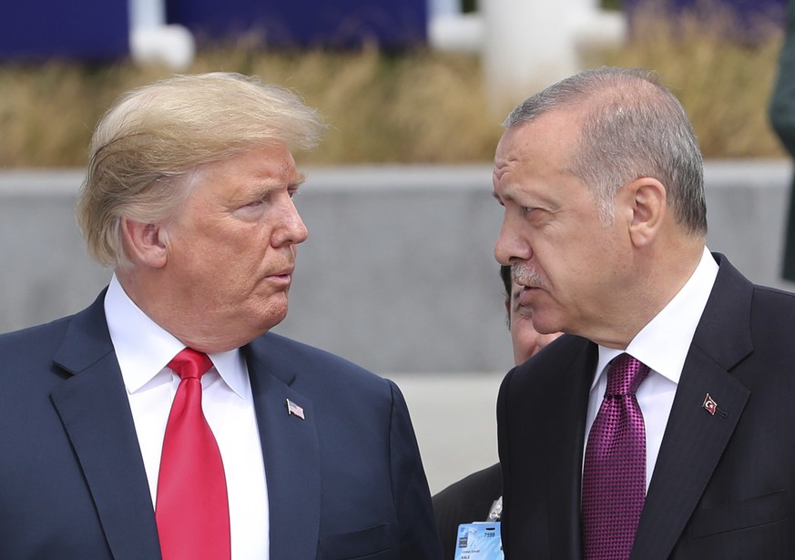 U.S. President Donald Trump, left, talks to Turkish President Recep Tayyip Erdogan, right, as they tour the new NATO headquarters in Brussels, Belgium, Wednesday, July 11, 2018. NATO countries&#039; h ...