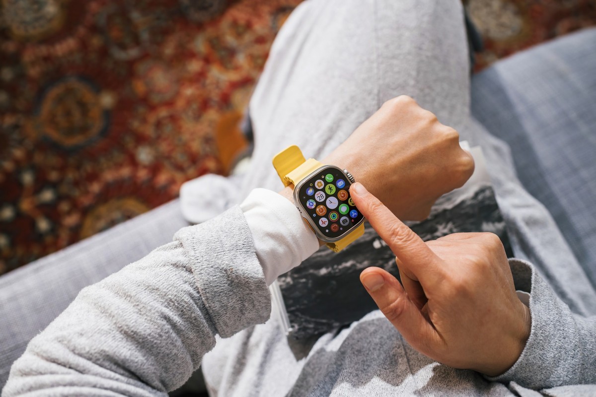 London, United Kingdom - Sep 28, 2022: Immerse yourself in the world of the new Apple Watch Series Ultra through the point of view of a woman&#039;s hand, exploring its interface with a loaded display ...