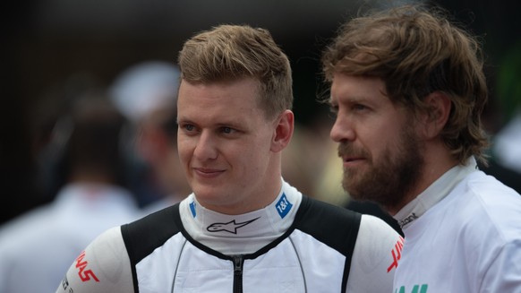 Miami Grand Prix - Race - Miami International Autodrome. (L to R): Mick Schumacher (GER) Haas F1 Team with Sebastian Vettel (GER) Aston Martin F1 Team on the grid. Miami Grand Prix, Sunday 8th May 202 ...