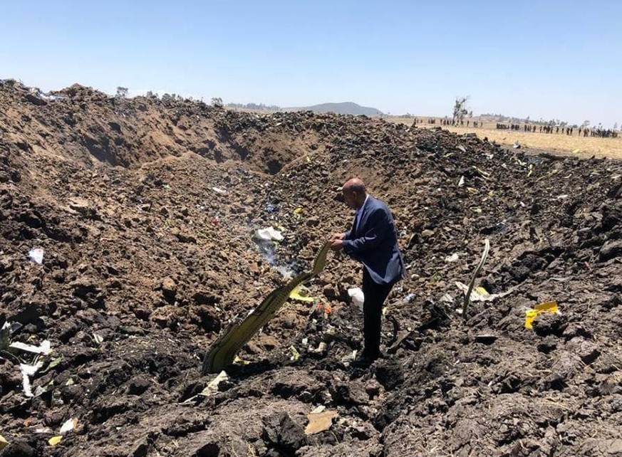 (190310) -- ADDIS ABABA, March 10, 2019 (Xinhua) -- A man checks the wreckage of the airplane of Ethiopian Airlines (ET) which crashed earlier near Bishoftu city, about 45 kms southeast of Addis Ababa ...