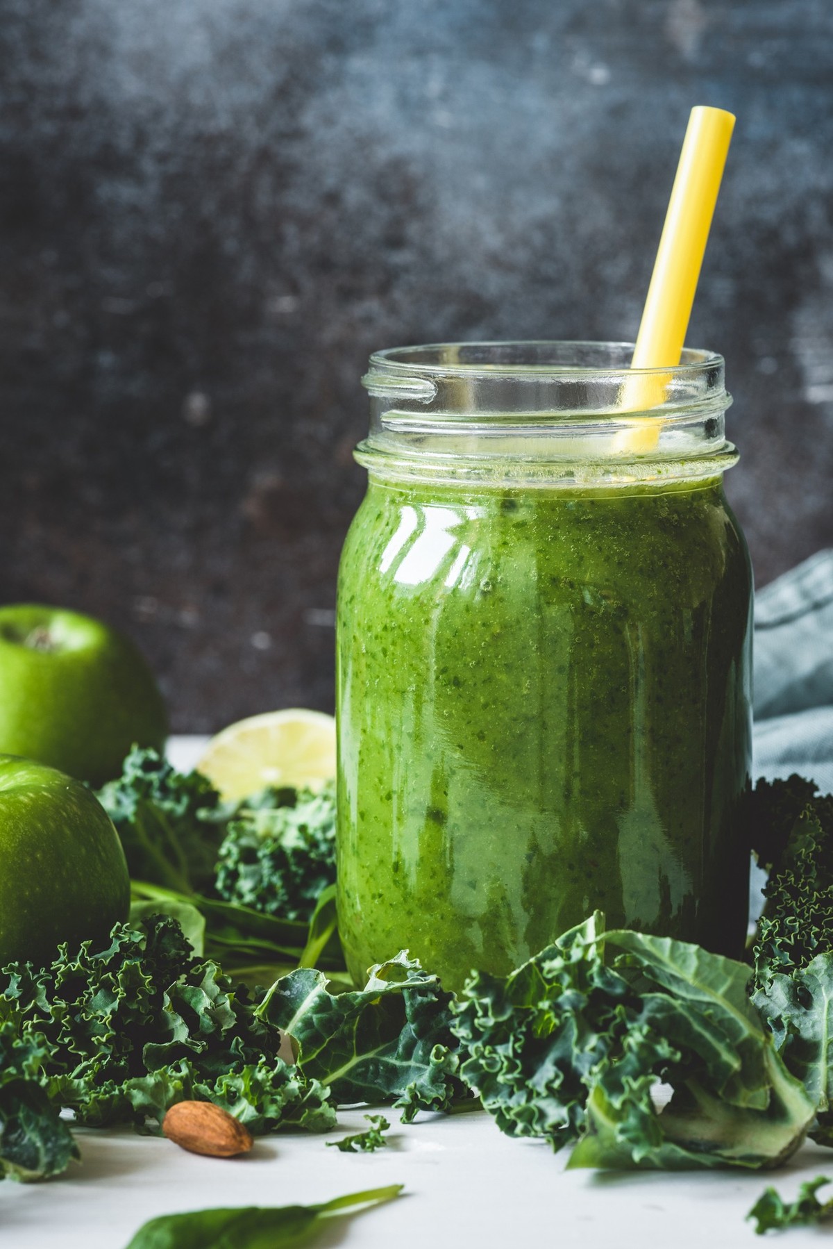 Green detox smoothie in a mug. Concept of vegetarian, vegan diet, detox, healthy lifestyle and healthy eating. Vertical, toned image.