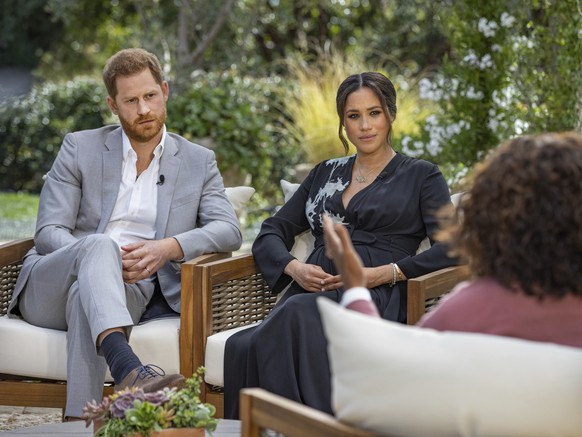 FILE - This image provided by Harpo Productions shows Prince Harry, from left, and Meghan, Duchess of Sussex, during an interview with Oprah Winfrey. (Joe Pugliese/Harpo Productions via AP, File)