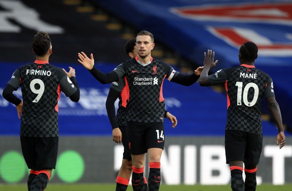 Liverpool's Jordan Henderson, centre, celebrates with teammates after scoring his side's fourth goal during the English Premier League soccer match between Crystal Palace and Liverpool at Selhurst Par ...
