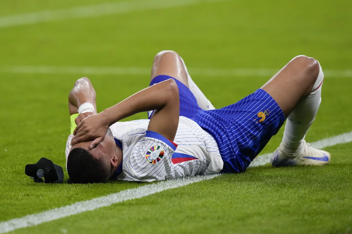 Kylian Mbappe of France reacts after an injury during a quarter final match between Portugal and France at the Euro 2024 soccer tournament in Hamburg, Germany, Friday, July 5, 2024. (AP Photo/Frank Au ...