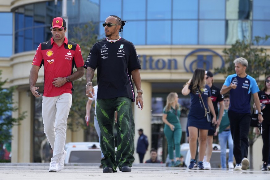 Mercedes driver Lewis Hamilton of Britain, right, talks to Ferrari driver Carlos Sainz of Spain at the Baku circuit, in Baku, Azerbaijan, Thursday, April 27, 2022. The Formula One Grand Prix will be h ...