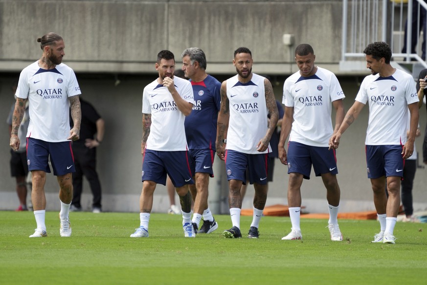Paris Saint-Germain soccer players, from left, Sergio Ramos, Lionel Messi, coach Christophe Galtier, Neymar, Kylian Mbappe and Marquinhos walk to participate during a PSG soccer lesson Monday, July 18 ...