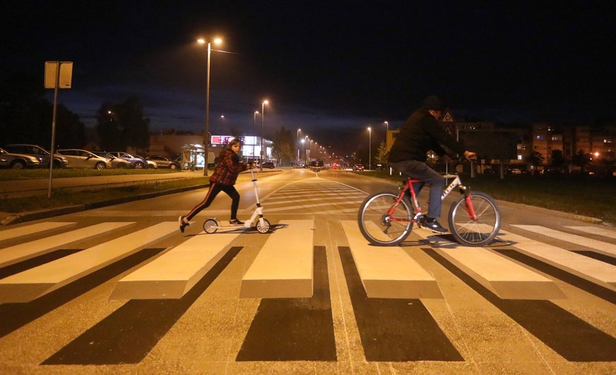 3D pedestrian crossing encourages drivers to slow down Photo taken on October 19, 2021 shows an innovative 3D pedestrian crossings in King Peter Kresimir IV Street, in Karlovac, Croatia. The striped c ...