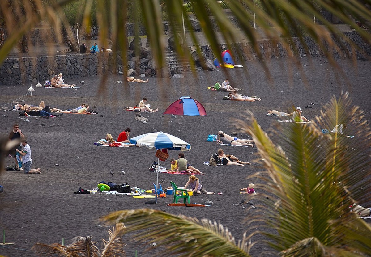 TENERIFE, SPAIN - MARCH 25: People at the black beach of Playa Jardin in Puerto de la Cruz on March 25, 2011 in Tenerife, Spain. Tenerife is the biggest of the canary islands and because of its warm c ...