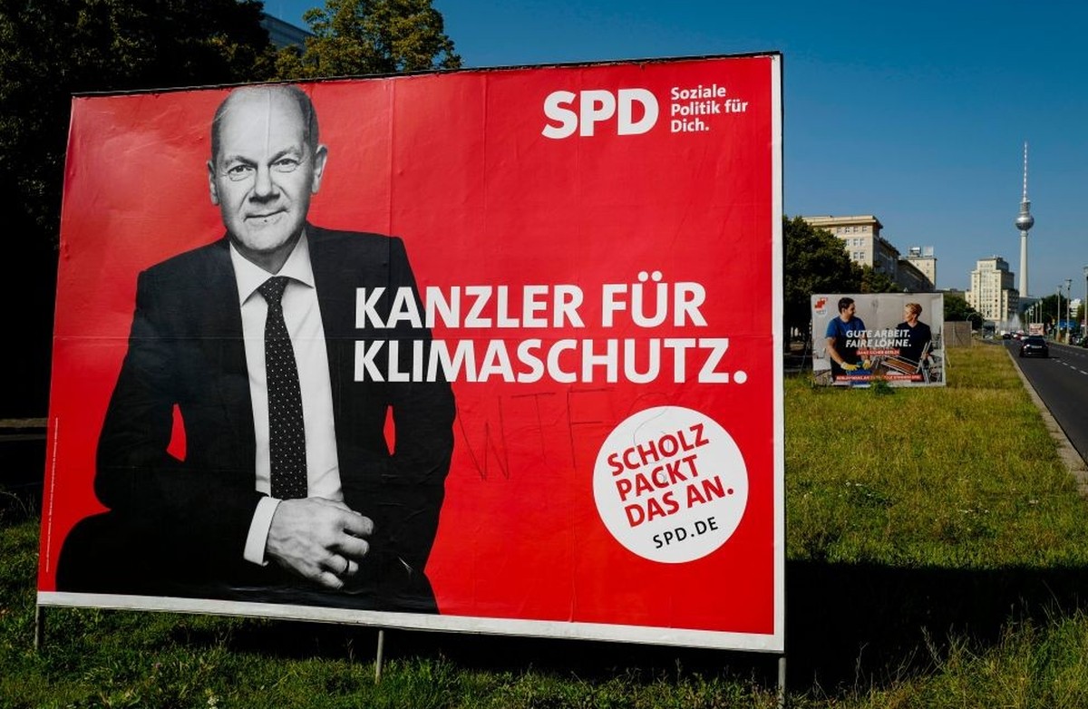 An election campaign poster featuring German Finance Minister, Vice-Chancellor and the Social Democratic Party&#039;s (SPD) chancellor candidate Olaf Scholz reads: &quot;A chancellor for climate prote ...