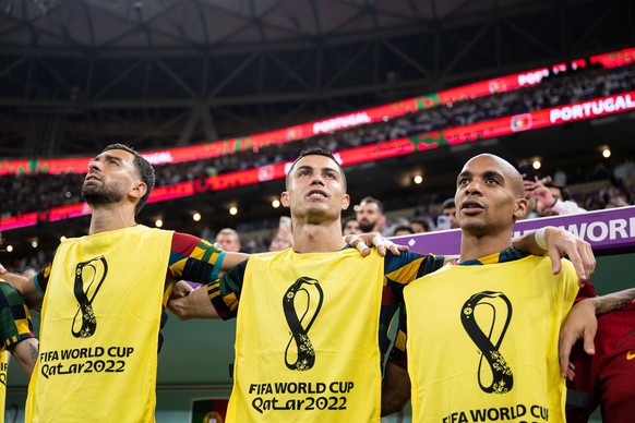 221206 Goalkeeper Rui Patricio, Cristiano Ronaldo and Joao Mario of Portugal on the bench during the national anthem ahead of the FIFA World Cup, WM, Weltmeisterschaft, Fussball 2022 round of 16 footb ...