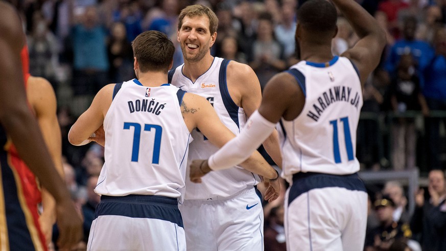 Mar 18, 2019; Dallas, TX, USA; Dallas Mavericks forward Luka Doncic (77) and forward Dirk Nowitzki (41) and guard Tim Hardaway Jr. (11) celebrate Nowitzki becoming the sixth all-time leading scorer in ...