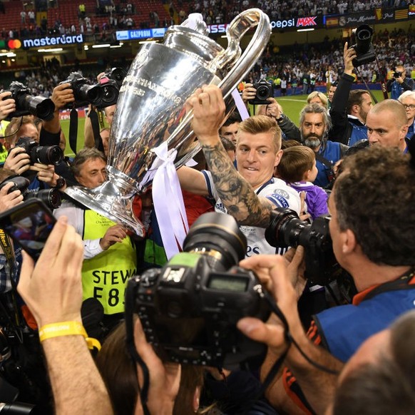 CARDIFF, WALES - JUNE 03: Toni Kroos of Real Madrid celebrates with The Champions League trophy after the UEFA Champions League Final between Juventus and Real Madrid at National Stadium of Wales on J ...