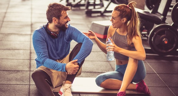 Let&#039;s take a bit of a breather. Personal trainer and sportswoman having conversation after exercise.