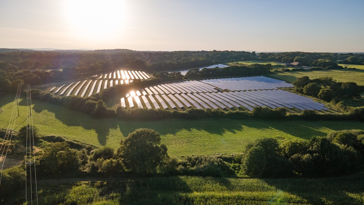 Aerial view of the solar panel in solar farm in evening sun light, West Sussex, UK.