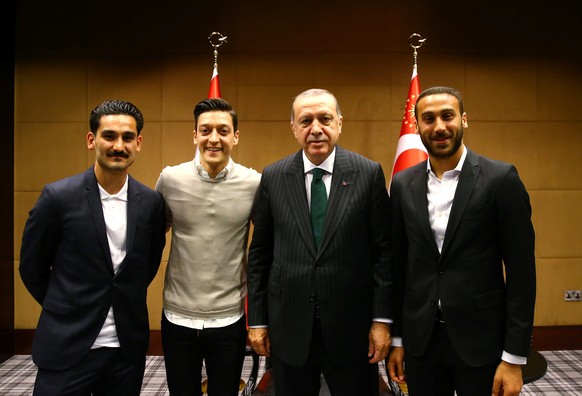 Turkish President Tayyip Erdogan meets with Premier League soccer players Ilkay Gundogan of Manchester City, Mesut Ozil of Arsenal and Cenk Tosun of Everton in London, Britain May 13, 2018. Picture ta ...