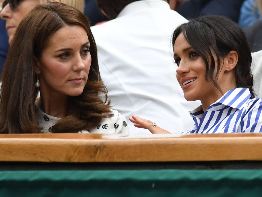 LONDON, ENG - JULY 14: Catherine, Duchess of Cambridge, and Meghan, Duchess of Sussex enjoying the women s singles final at the Wimbledon Championships on July 14, 2018 played at the AELTC, London, En ...