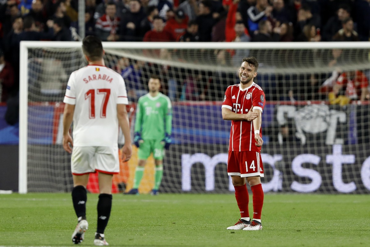 Bayern's Juan Bernat, right, gestures to Sevilla's Pablo Sarabia after Sarabia scored his side's opening goal during the Champions League quarter final first leg soccer match between Se ...