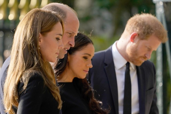 10.09.2022, Großbritannien, Windsor: Kate, Prinzessin von Wales (l-r), Prinz William, Meghan, Herzogin von Sussex, und Prinz Harry betrachten die Blumen und letzte Grüße, die Trauernde auf Schloss Win ...