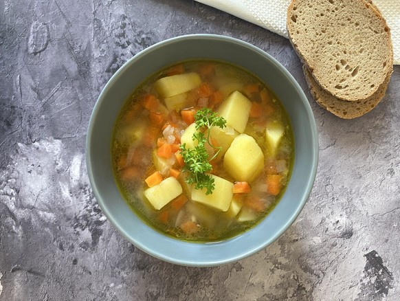 Healthy vegetarian potato soup with carrots, celery and parsley.