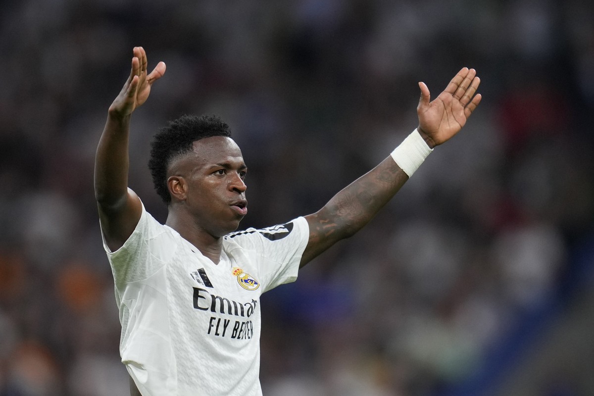 Real Madrid's Vinicius Junior celebrates after scoring his side's fourth goal during the Champions League opening phase soccer match between Real Madrid and Borussia Dortmund at the Santiago ...