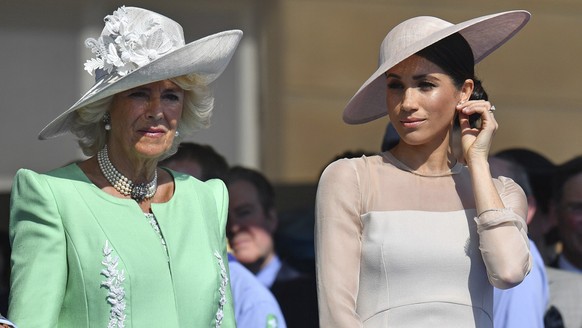 FILE - Meghan, the Duchess of Sussex, right, stands with Camilla, the Duchess of Cornwall, during a garden party at Buckingham Palace in London, Tuesday May 22, 2018. Britain&#039;s Prince Harry has d ...