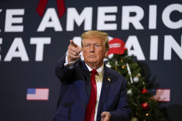 FILE - Former President Donald Trump points to supporters during rally Dec. 19, 2023, in Waterloo, Iowa. (AP Photo/Charlie Neibergall, File)