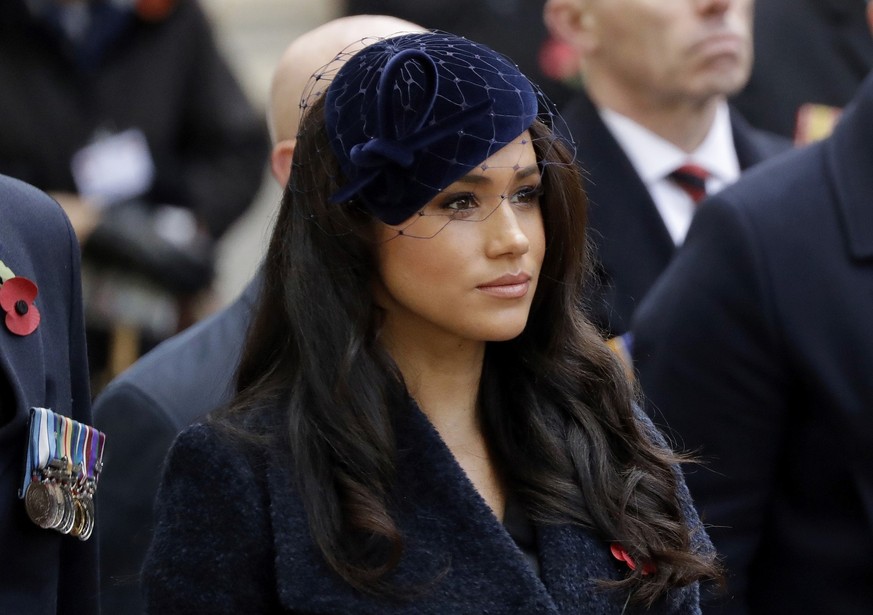 FILE - In this Thursday, Nov. 7, 2019 file photo Meghan the Duchess of Sussex stands after she and her husband Britain&#039;s Prince Harry placed a Cross of Remembrance as they attend the official ope ...