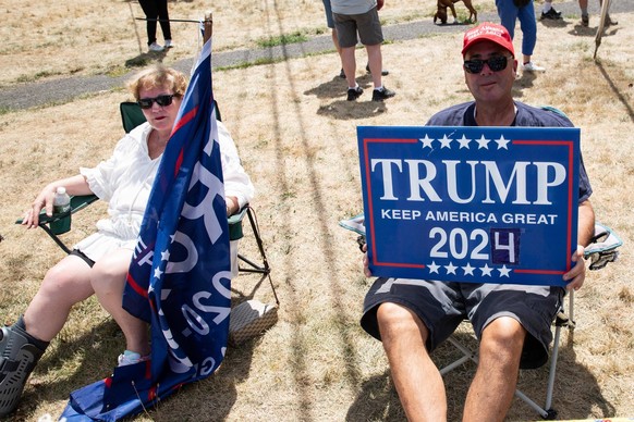 August 14, 2022, Bedminster, New Jersey, United States: A protester holds a Trump sign during the Trump supporters rally. Trump supporters rally at the corner of Lamington Road and Route 206 near the  ...