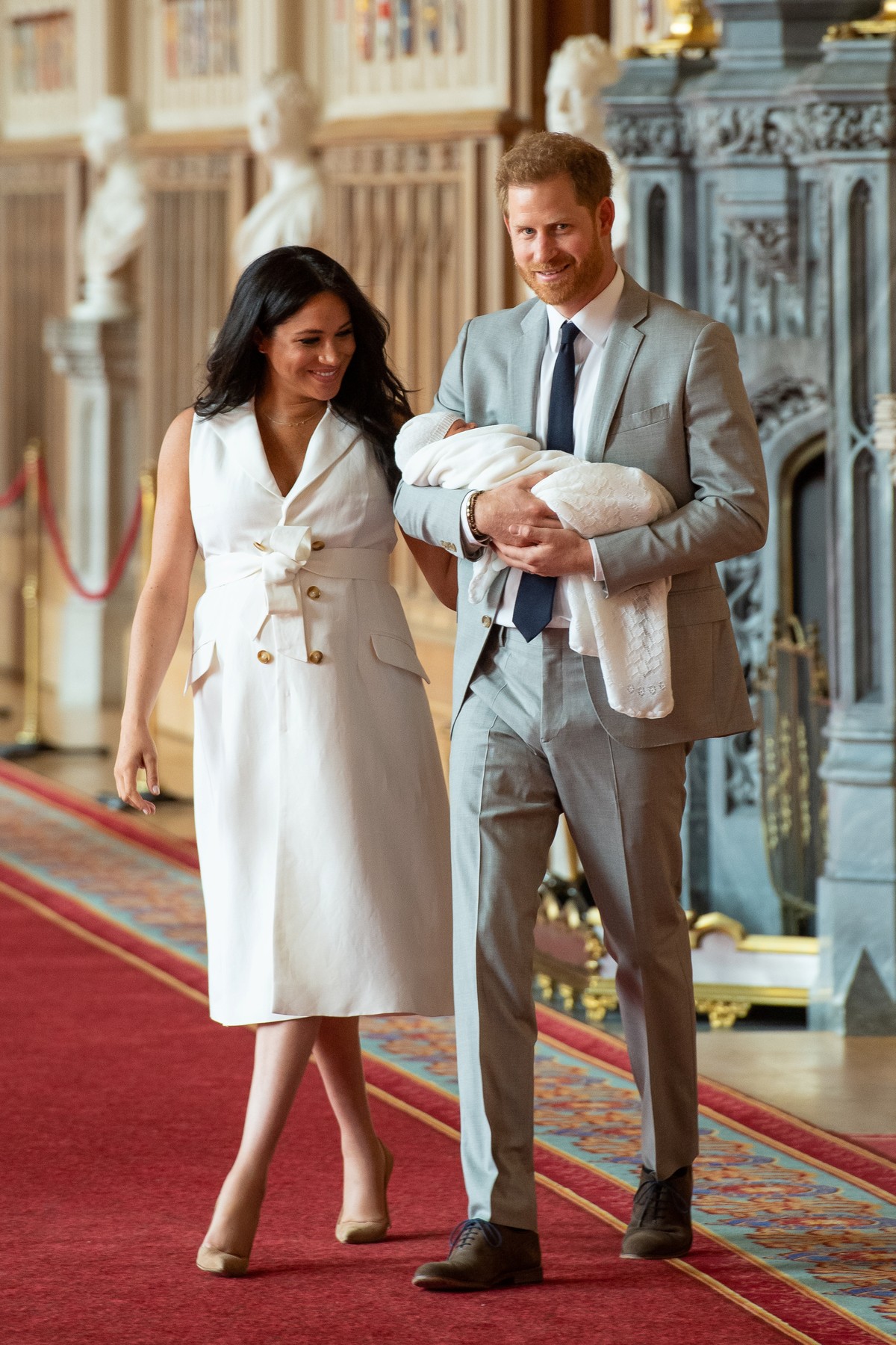 Britain&#039;s Prince Harry and Meghan, Duchess of Sussex are seen with their baby son, who was born on Monday morning, during a photocall in St George&#039;s Hall at Windsor Castle, in Berkshire, Bri ...