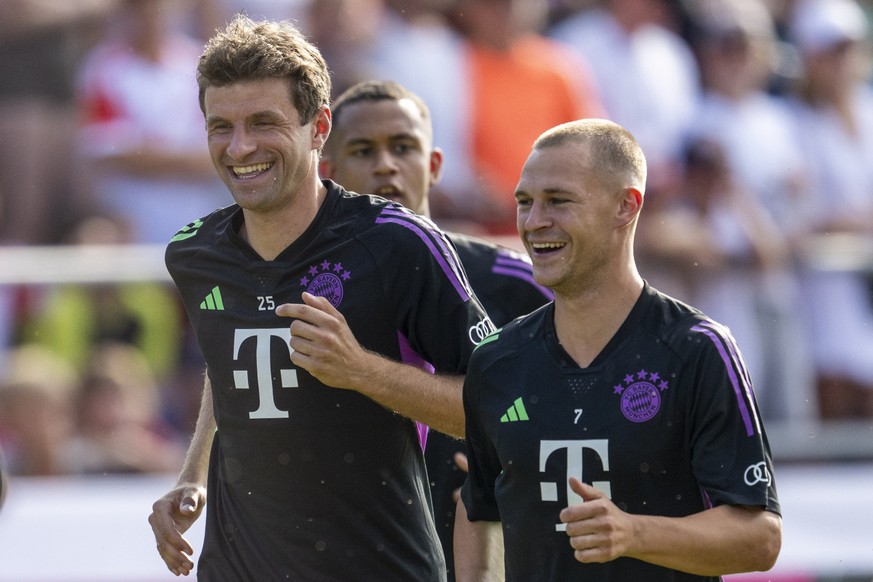 ARCHIV - 15.07.2023, Bayern, Rottach-Egern: Fußball: Bundesliga, Beginn Trainingslager des FC Bayern München: Münchens Thomas Müller (l.) und Münchens Joshua Kimmich laufen sich warm und lachen dabei. ...