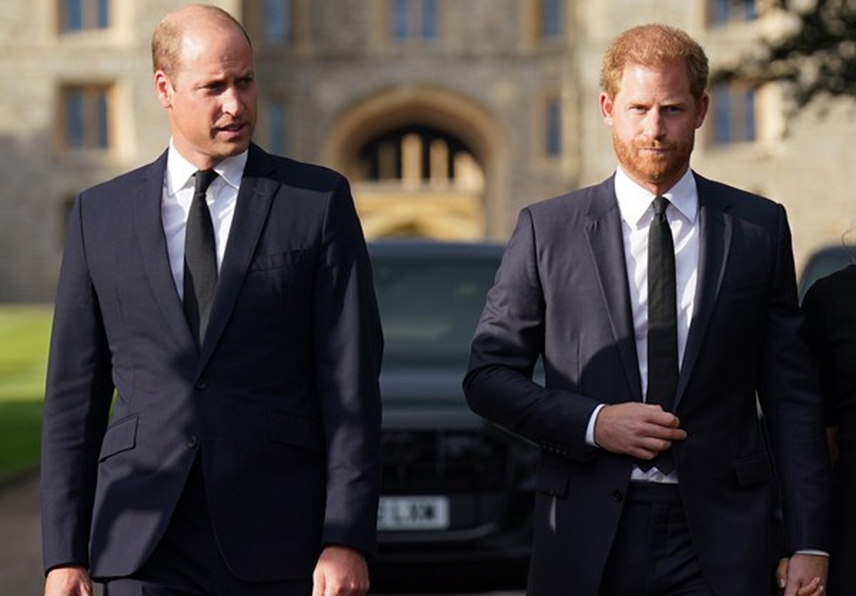 WINDSOR, ENGLAND - SEPTEMBER 10: Prince William, Prince of Wales and Prince Harry, Duke of Sussex walk together to meet members of the public on the long Walk at Windsor Castle on September 10, 2022 i ...