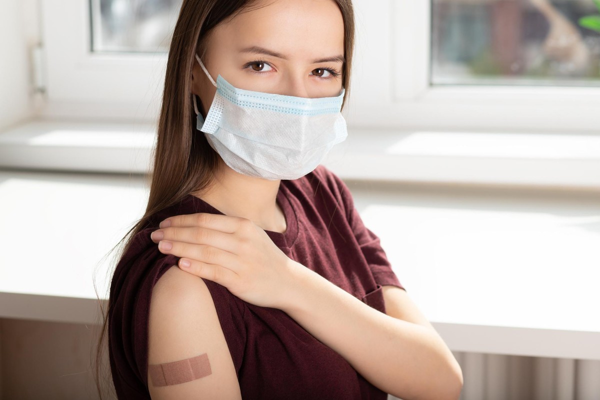 Vaccination of teenagers from covid-19, a young girl after inoculation in a medical hospital