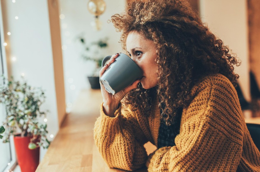 Attractive woman drinking coffee at the cafe.