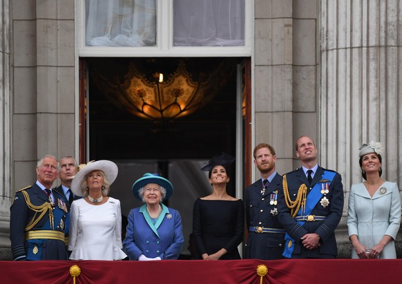 RAF centenary. (left to right) Prince of Wales, Duke of York (obscured), the Duchess of Cornwall, Queen Elizabeth II, Duchess of Sussex, Duke of Sussex, Duke of Cambridge and Duchess of Cambridge on t ...