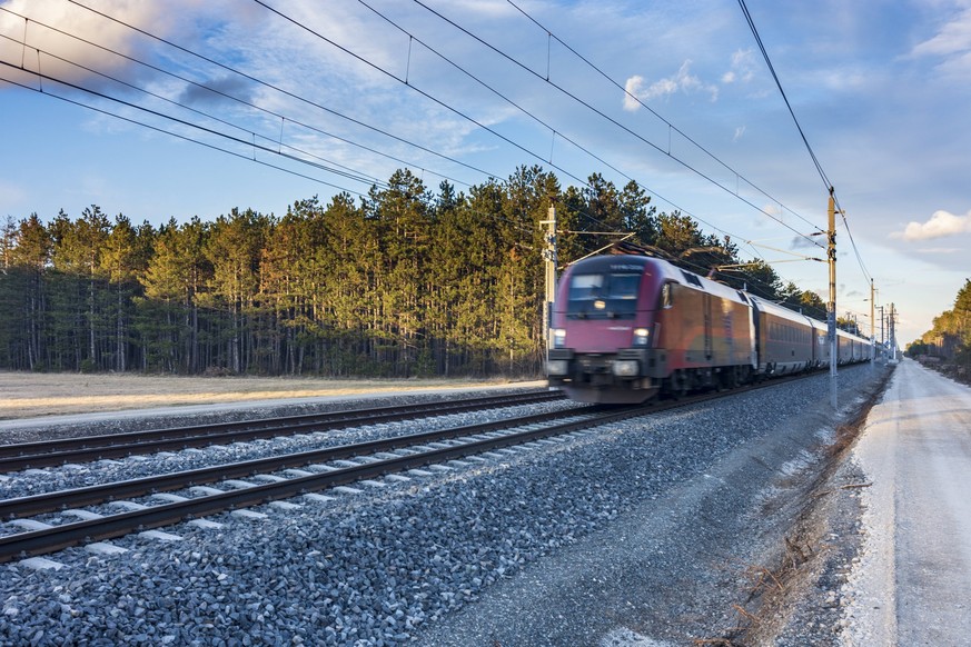 railway line Südbahn in Steinfeld area, Railjet train of ÖBB, electrified route, catenary poles Neunkirchen Niederösterreich, Lower Austria Austria Wiener Alpen, Alps