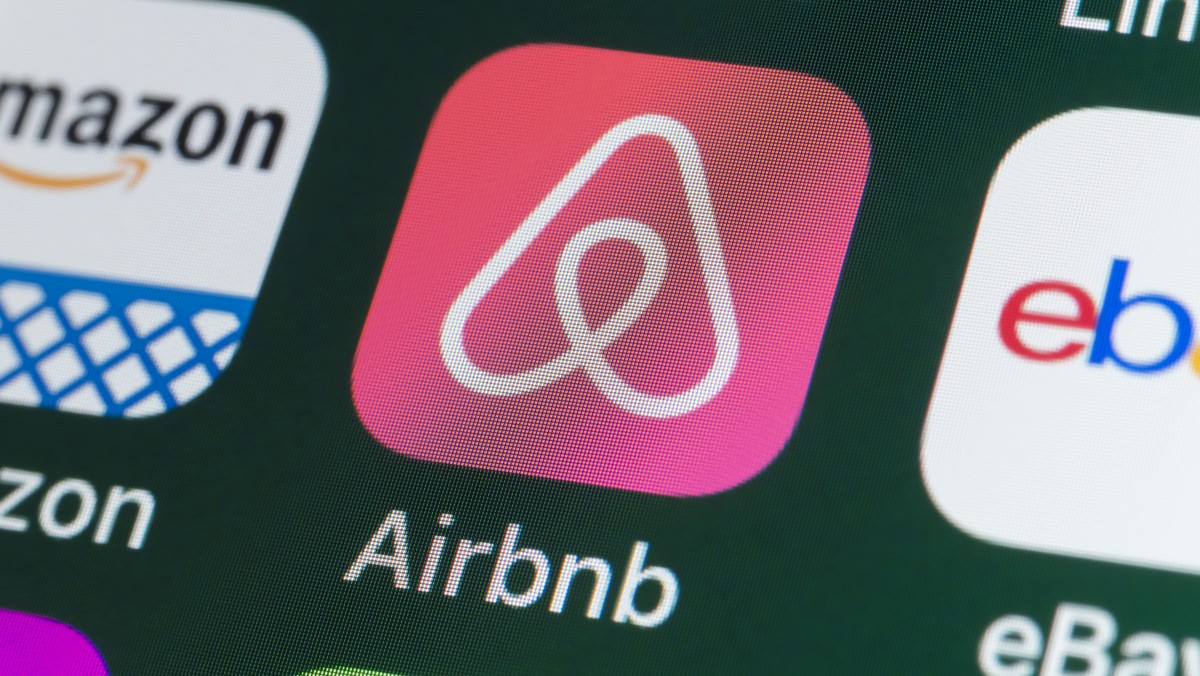 London, UK - July 31, 2018: The buttons of the travel app Airbnb, surrounded by Amazon, ebay, News and other apps on the screen of an iPhone.